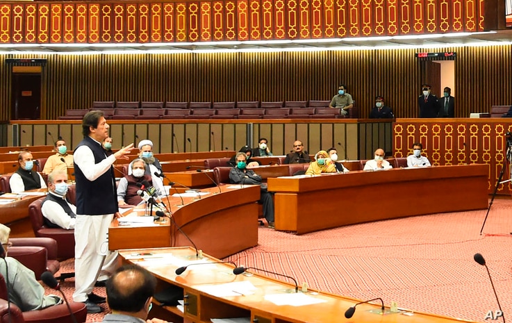 In this photo released by the Press Information Department, Pakistani Prime Minister addresses the Parliament in Islamabad, Pakistan, June 25, 2020. Khan accused the United States on Thursday of having 