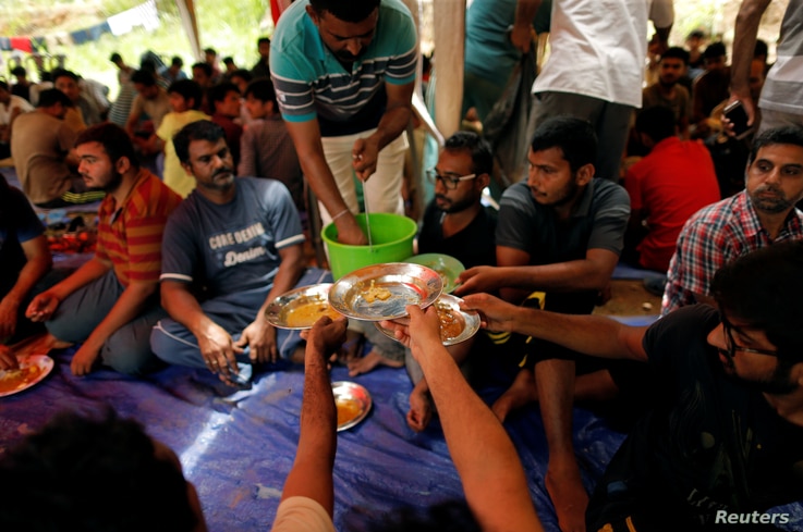 FILE - Ahmadi refugees from Pakistan eat at the Ahmadiyya Muslim Community Center in Pasyala, Sri Lanka, April 26, 2019. 