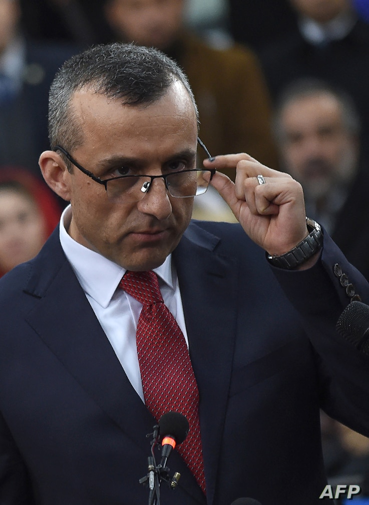 First vice-presidential candidate Amrullah Saleh looks on as he speaks to the media after arriving at the Independent Electoral…
