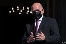 Iraqi Foreign Minister Fuad Hussein gestures as he arrives for a meeting with his Greek counterpart in Athens, on Friday, Feb…