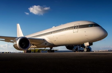 A side profile of the Boeing, bearing tail number P4-BDL and serial number 37306, parked on the ground.