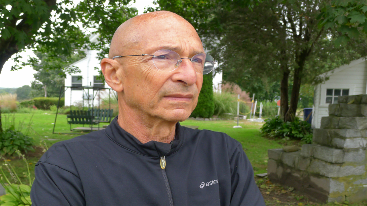 A portrait of a man outside.