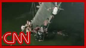 Video shows people clinging to wreckage after bridge crash kills dozens in India