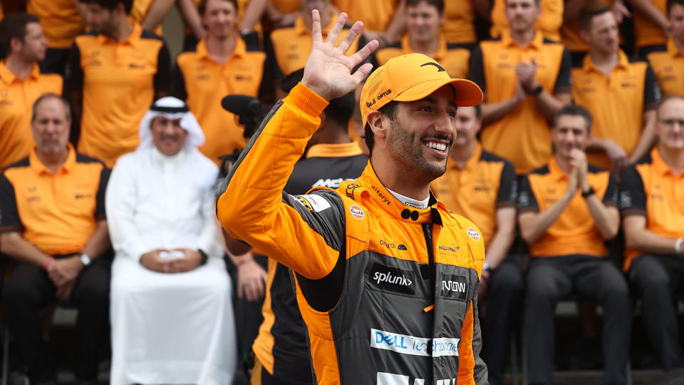 Daniel Ricciardo waves during a farewell photo opportunity with the McLaren F1 team.