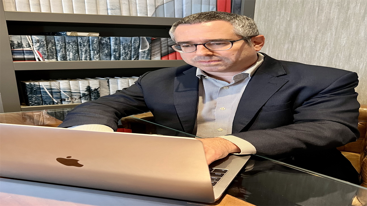 A photo shows Dr. Corey Siegel using a laptop.