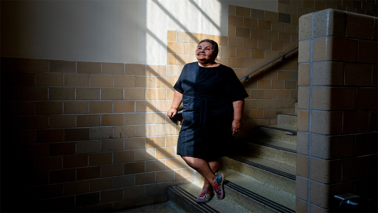 A portrait of a woman posing in a stairwell.