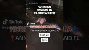 Woman swims in floodwater
