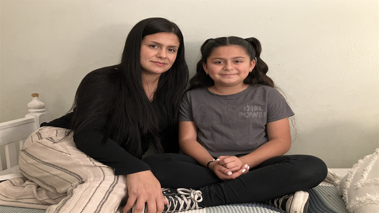 Anjelah Salazar sits on her bed beside her mom, Rosanna Chavira.