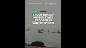 Truck narrowly avoids state trooper in winter storm