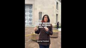 Trump banner hung outside DOJ HQ